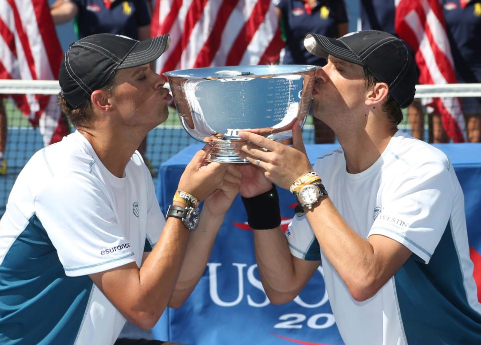 Bob, left, and Mike Bryan kiss the men's doubles championship trophy after winning the 2014 U.S. Open title. The Camarillo twins will be Tournament Honorees for the 122nd Ojai Tennis Tournament, which is set for April 24-28.