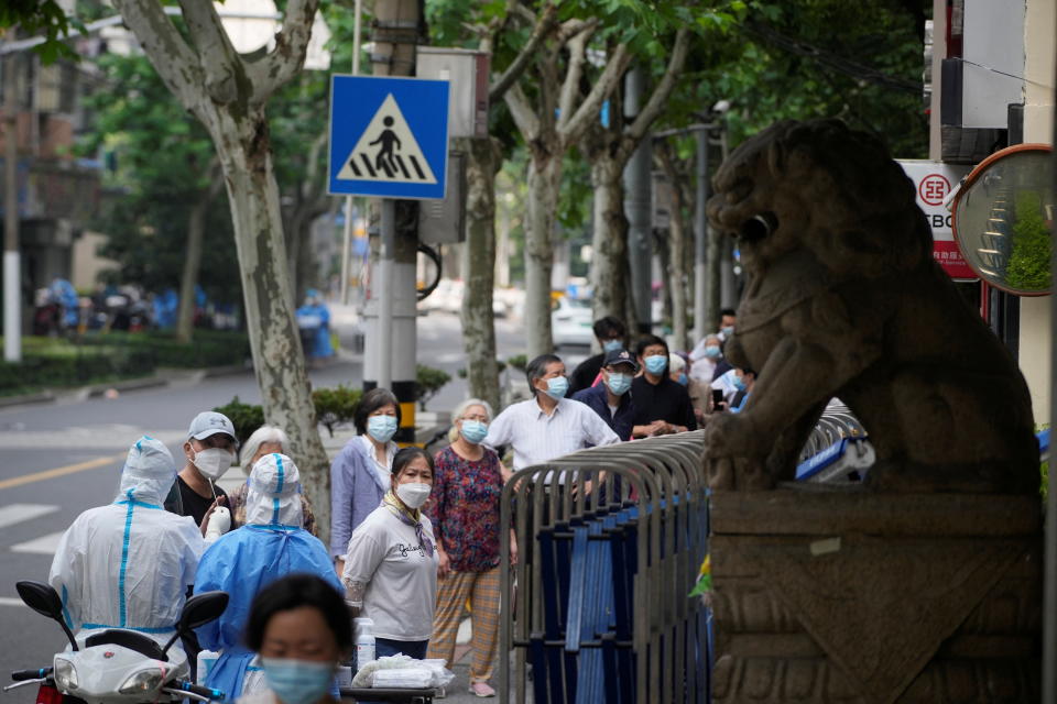 Residents line up for nucleic acid tests on a street during lockdown, amid the coronavirus disease (COVID-19) outbreak, in Shanghai, China, May 30, 2022. REUTERS/Aly Song