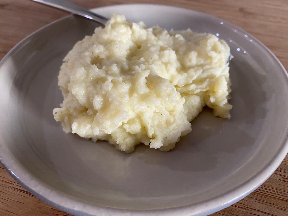 pile of blue cheese mashed potatoes on a gray plate