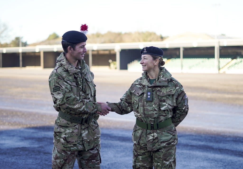 Lt Col Shamus Kelly shakes the hand of his wife, Lt Col Lyndsey Kelly, as he exchanges the command of 1ATR (Army Training Regiment) to her (Steve Parsons/PA) (PA Wire)