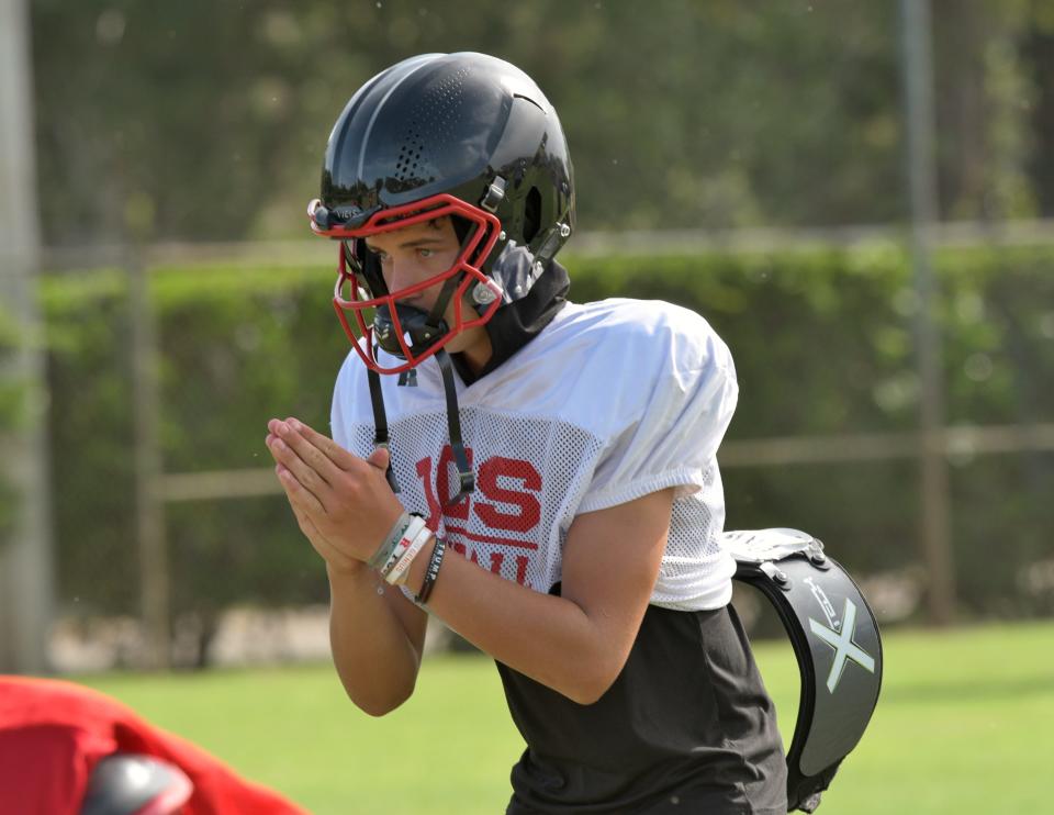 Jupiter Christian quarterback Joe Sacerio prepares for the snap during football drills at practice. Sacerio was touted as a standout player by the coaching staff following an impressive offseason on Aug. 11, 2022.