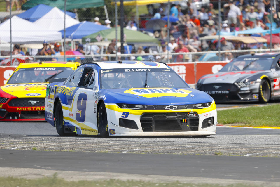 Chase Elliott (9) leads a group through a turn during a NASCAR Cup Series auto race Sunday, July 4, 2021, at Road America in Elkhart Lake, Wis. (AP Photo/Jeffrey Phelps)