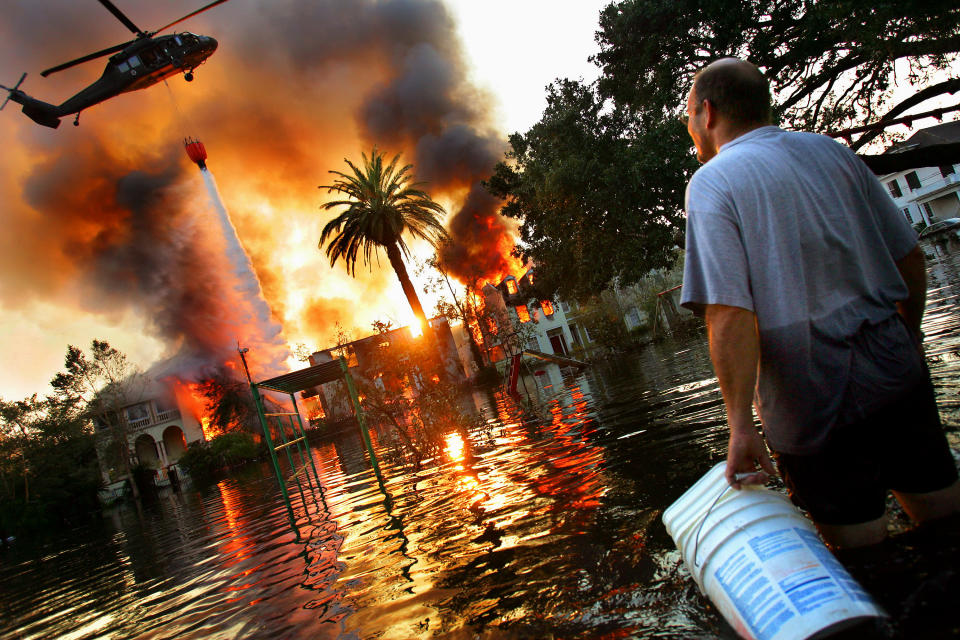 A helicopter tries to extinguish a fire in New Orleans after Hurricane Katrina. Because of the extensive flooding caused by the breaking of the city’s levies, fire trucks were unable to reach burning homes, and in some cases whole blocks burned to the ground. (Photo: Craig Warga/NY Daily News Archive via Getty Images)