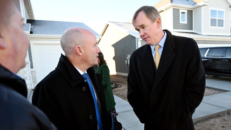 Gov. Spencer Cox talks with Steve Waldrip, who was introduced as the senior adviser for housing strategy and innovation prior to the governor announcing his state budget proposal at a press conference in West Haven on Tuesday, Dec. 5, 2023.