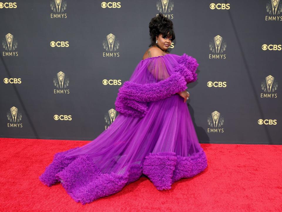 Nicole Byer wears a purple dress on the Emmys red carpet.