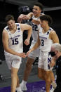 Northwestern forward Pete Nance, center, celebrates with center Ryan Young and guard Ty Berry after Northwestern defeated Maryland 60-55 in an NCAA college basketball game in Evanston, Ill., Wednesday, March 3, 2021. (AP Photo/Nam Y. Huh)