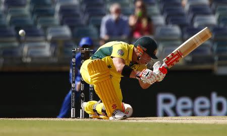 Australia's batsman David Warner misses sweeping the ball during a delivery from Afghanistan during their Cricket World Cup match in Perth March 4, 2015. REUTERS/David Gray