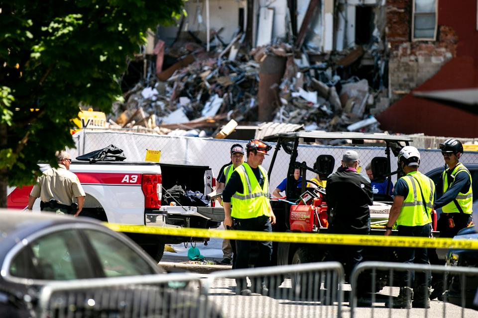 A crew from the Bettendorf Technical Rescue Team assembles on Tuesday, May 30, 2023, near the site of an apartment building that partially collapsed in Davenport, Iowa. The six-story building at 324 Main St. partially collapsed on May 28.