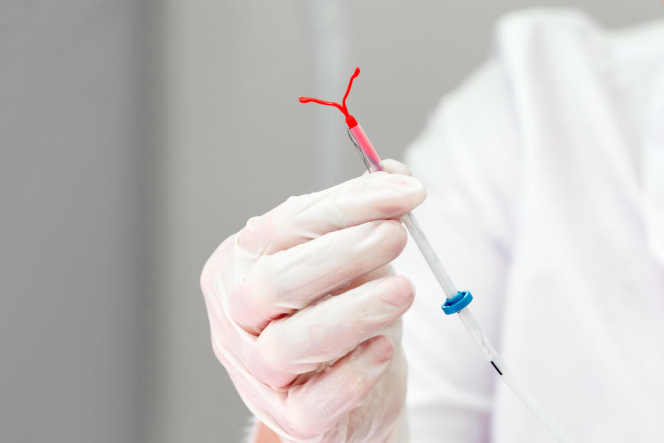 Holding an IUD birth control coil device. (Getty Images)