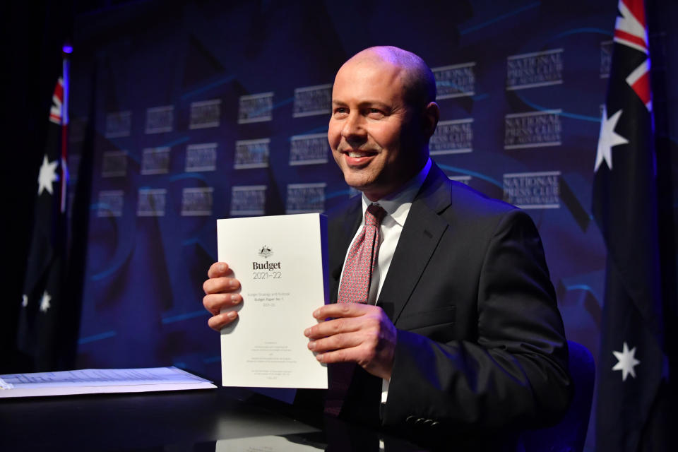 Federal Treasurer Josh Frydenberg holds a copy of the 2021-2022 Federal Budget