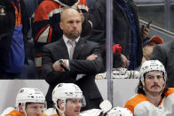 Philadelphia Flyers interim head coach Mike Yeo looks on during the third period of an NHL hockey game against the New York Islanders, Tuesday, Jan. 25, 2022, in Elmont, N.Y. (AP Photo/Corey Sipkin).