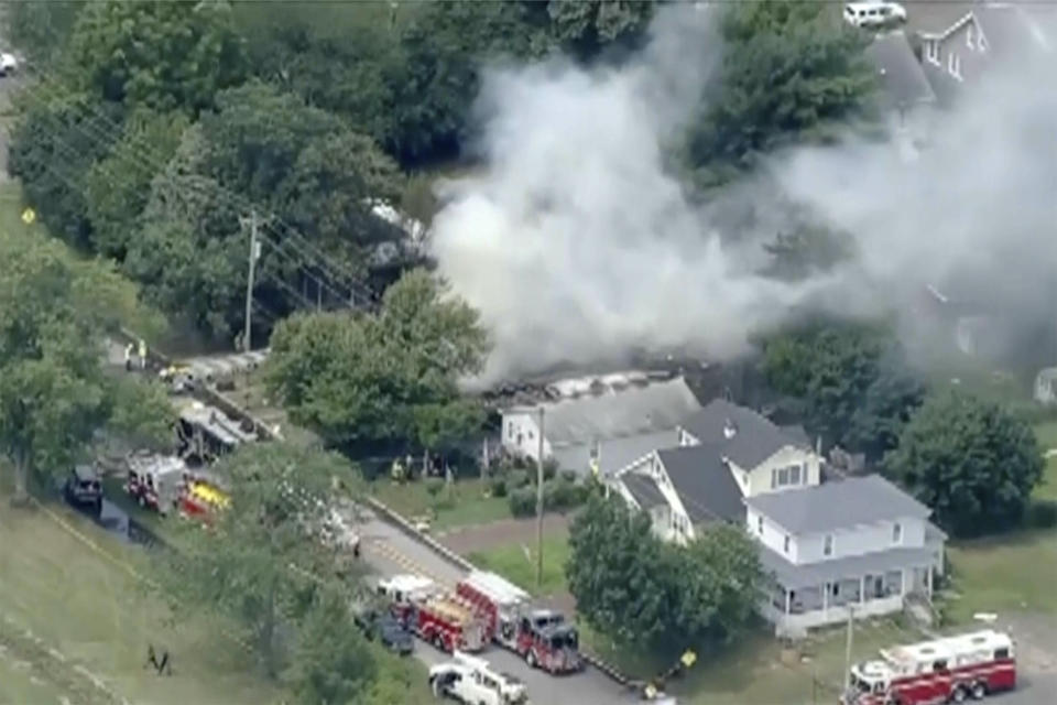 In this image taken by video from WPVI, fire crews try to extinguish an fire at a home Thursday, Aug. 3, 2023, in Buena, southern N.J. An explosion has destroyed the house and left two people dead and two children seriously injured. Authorities are still searching for two other people they believe were inside. (WPVI-TV via AP)