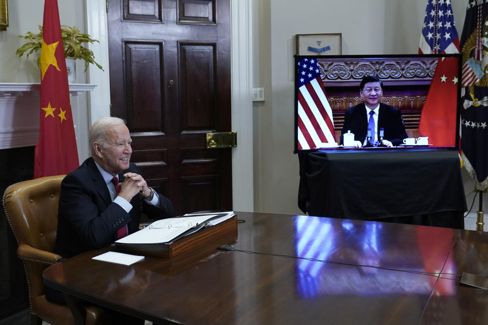 President Joe Biden, left, speaks as he meets virtually with Chinese President Xi Jinping, on screen, from the Roosevelt Room of the White House in Washington, Monday, Nov. 15, 2021. (AP Photo/Susan Walsh)