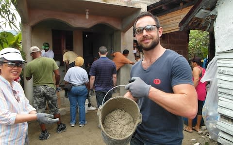 James Litston holding a bucket of concrete