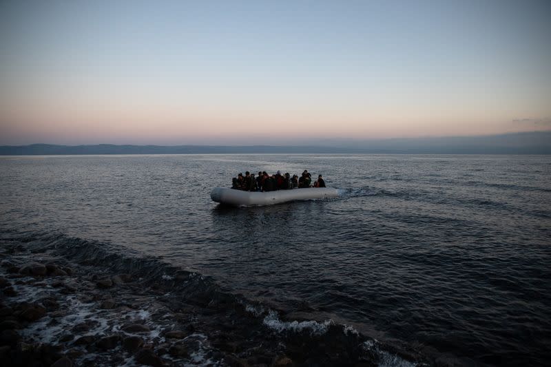 Migrants from Afghanistan arrive on a dinghy on a beach near the village of Skala Sikamias, after crossing part of the Aegean Sea from Turkey to the island of Lesbos