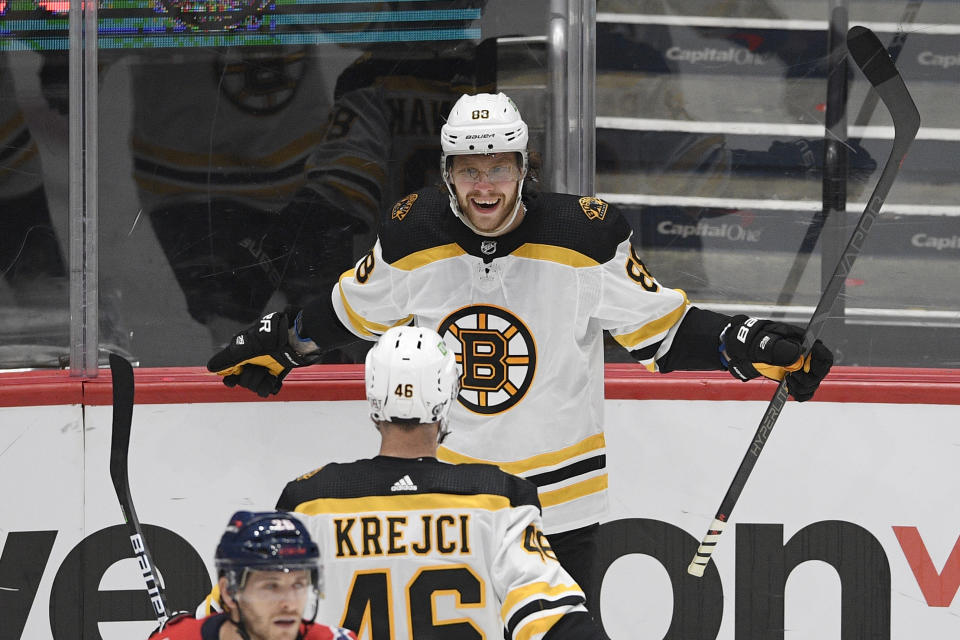 Boston Bruins right wing David Pastrnak (88) celebrates his goal with center David Krejci (46) during the second period in Game 5 of an NHL hockey Stanley Cup first-round playoff series against the Washington Capitals, Sunday, May 23, 2021, in Washington. (AP Photo/Nick Wass)