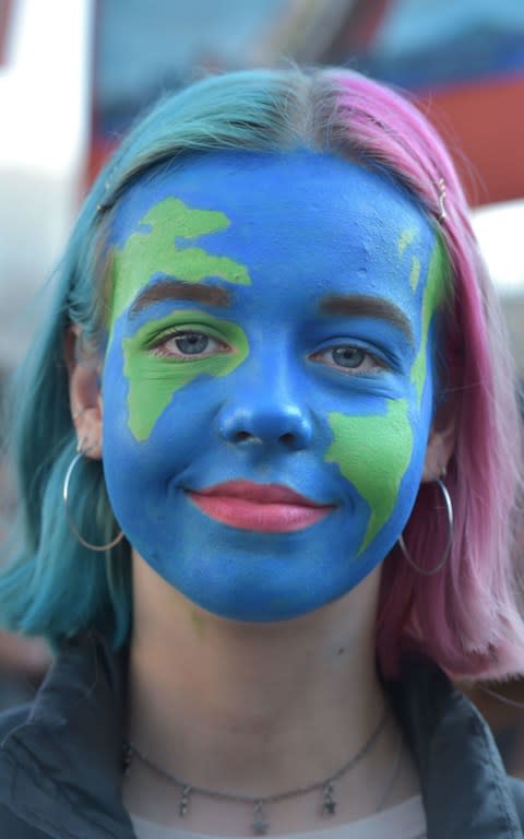 Young student, Rosie, picture at the climate change protest in Parliament Square - Credit: Nick Ansell/PA