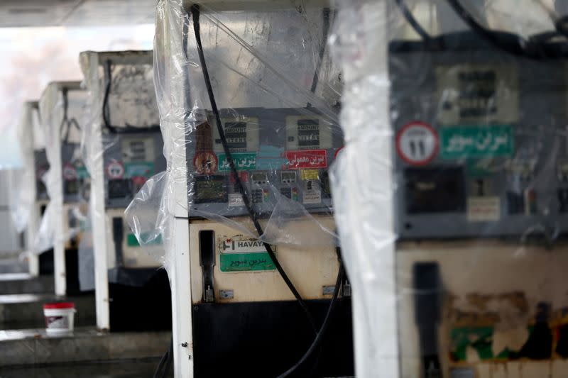 FILE PHOTO: Destroyed petrol pumps are pictured at a gas station, after protests against increased fuel prices, in Tehran