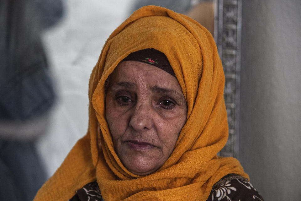 Zina Sehi looks at her son, Hosni Kalaia, in Kasserine, Tunisia, Friday, Dec.11, 2020. Hundreds of desperate Tunisians have set themselves on fire in the past 10 years as an act of protest. In 2014, Sehi, now 68, tried to burn herself to death in front of the president’s palace in Tunis, protesting the government’s lack of financial support for the family. (AP Photo/Riadh Dridi)