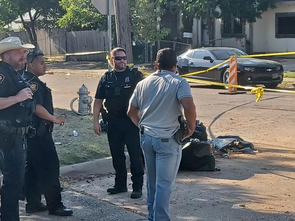 Fort Worth police investigate at the scene of Ross Avenue and NW 32nd Street, where officers shot and killed two armed men on Wednesday. Tom Johanningmeier/tjohanningmeier@star-telegram.com