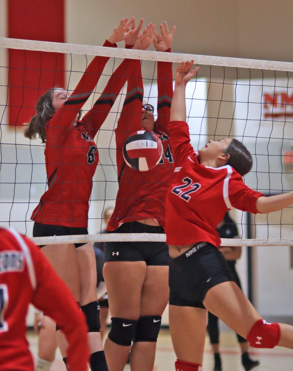 Loving's Mya Vasquez (right) is rejected at the net during a 2022 volleyball match against New Mexico Military Institute in Roswell.