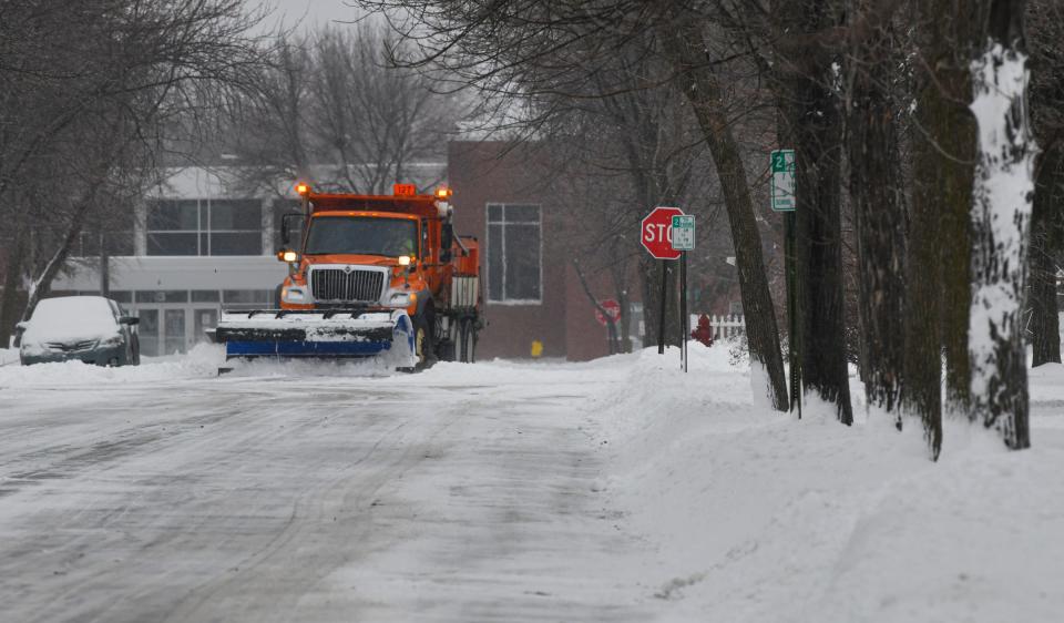 A city plow removes snow on a street on the north side of St. Cloud Monday, Dec. 27, 2021.