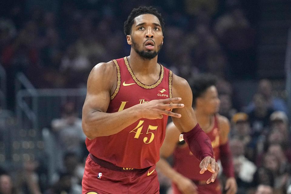 Cleveland Cavaliers guard Donovan Mitchell (45) gestures after hitting a 3-point basket in the first half of an NBA basketball game against the Philadelphia 76ers, Monday, Feb. 12, 2024, in Cleveland. (AP Photo/Sue Ogrocki)