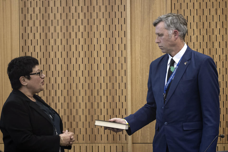 Detective Senior Sergeant Craig Farrant, right, is sworn in as a witness during a coroner's inquiry in Christchurch, New Zealand, Tuesday, Oct. 24, 2023, into the 2019 mosque shootings. The inquiry into New Zealand’s worst mass-shooting will examine, among other issues, the response times of police and medics and whether any of the 51 people who were killed could have been saved. (Iain McGregor/Pool Photo via AP)