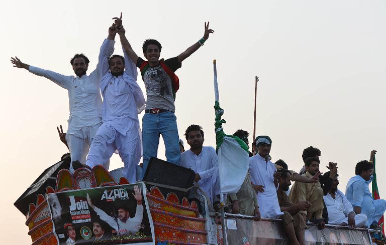 Supporters of Pakistani cricketer-turned-politician Imran Khan travel in Swabi on August 14, 2014, as they journey towards Islamabad