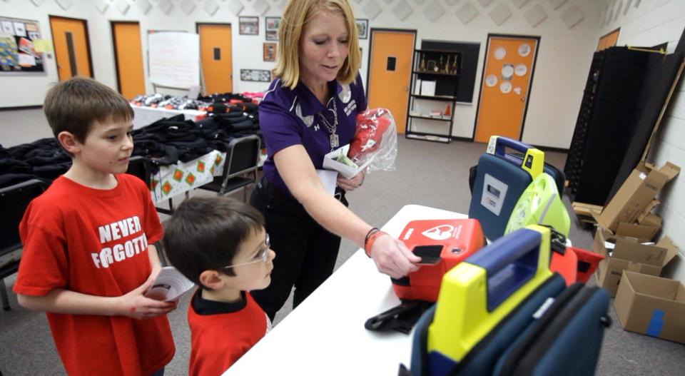 Braden Griffin, left, and Nathan Griffin, of Fennville, check out the AEDs that Jocelyn Leonard was showing them on Jan 6, 2012. Both boys donated $100 of their Christmas money to the Wes Leonard Heart Team foundation. Jocelyn's son Wes Leonard died on the basketball court after hitting the game-winning shot on March 3, 2011.