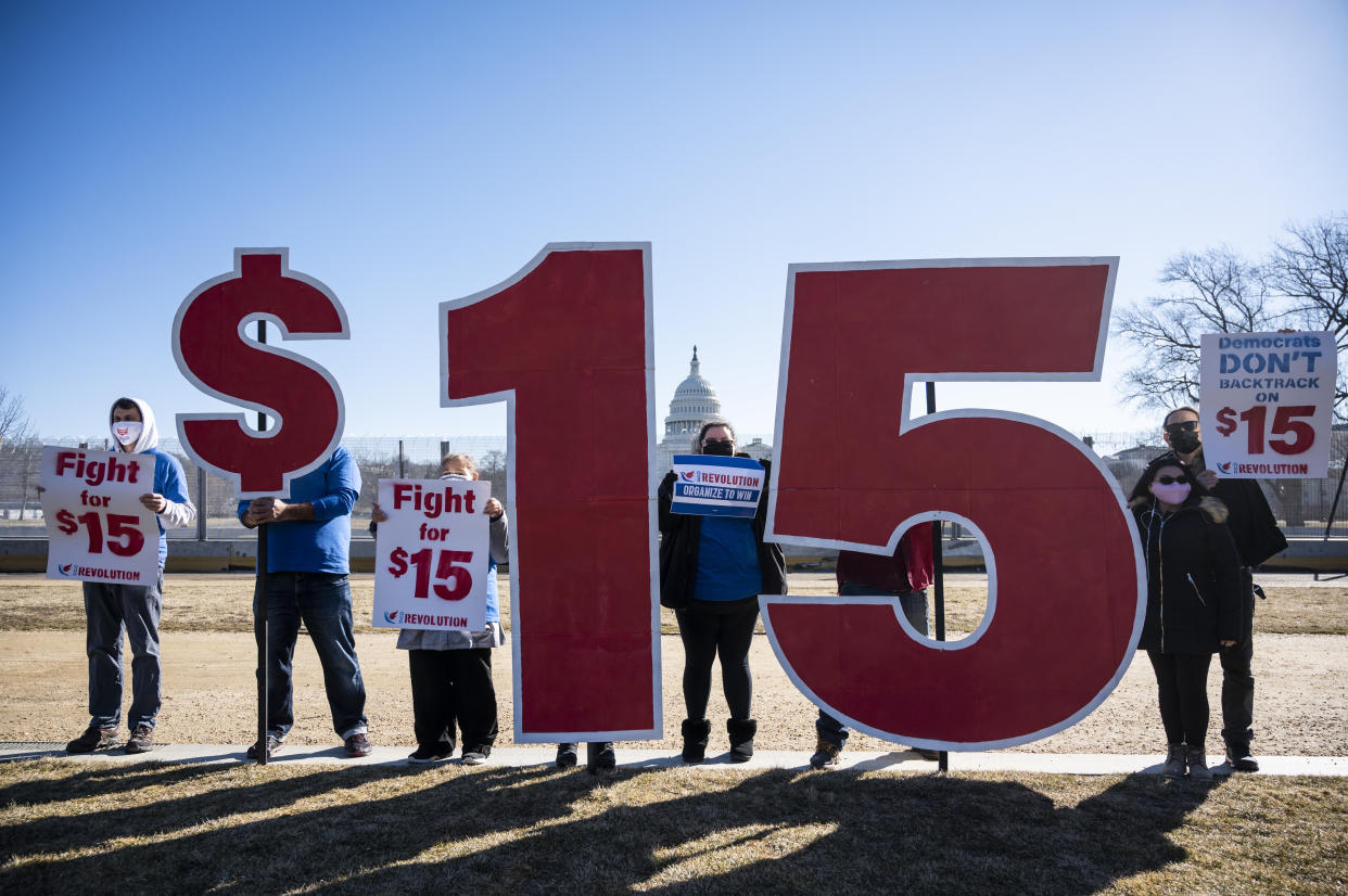 Activists with Our Revolution hold $15 minimum wage signs outside the Capitol complex on Thursday, Feb. 25, 2021, to call on Congress to pass the $15 federal minimum wage hike proposed as part of the COVID relief bill.  (Photo: Bill Clark via Getty Images)