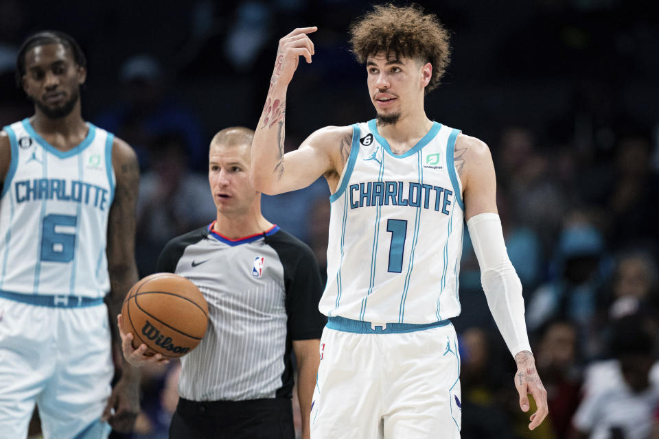 Charlotte Hornets guard LaMelo Ball (1) signals to be subbed out of the game after being shaken up on a play in the second half of an NBA preseason basketball game against the Washington Wizards in Charlotte, N.C., Monday, Oct. 10, 2022. (AP Photo/Jacob Kupferman)