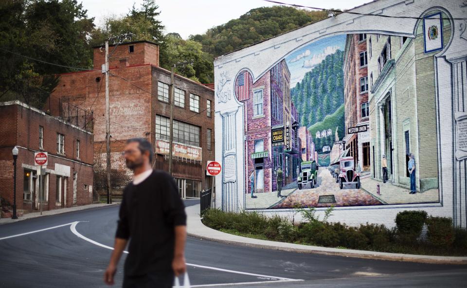 A mural depicting a more vibrant time in the town's history decorates a building in the business district,Oct. 6, 2015, in Welch, W.Va. Poverty experts say these efforts helped relieve the most acute conditions, but did little else. As coal employment declined, people fled because there was little else for them to do. McDowell County, home to Welch, had a population of just under 100,000 in 1950. Since then, the county's population has fallen by four-fifths, to around 20,000. (Photo: David Goldman/AP)