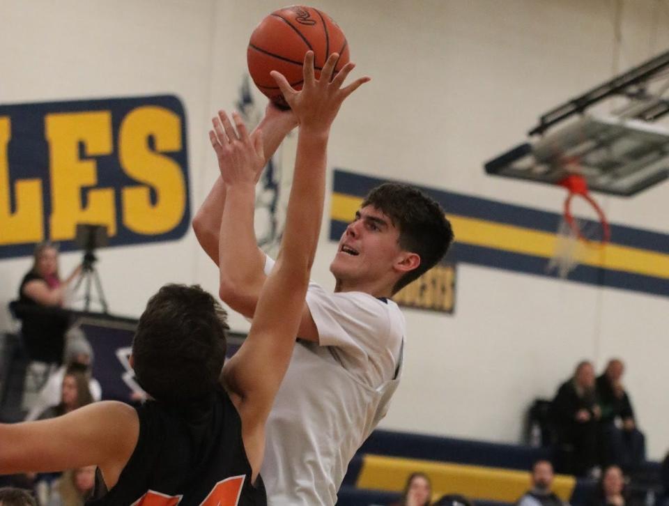 Wyatt Knopp of Erie Mason goes up for a shot over Summerfield’s Zack Stambaugh during a 73-42 Mason win Thursday night.