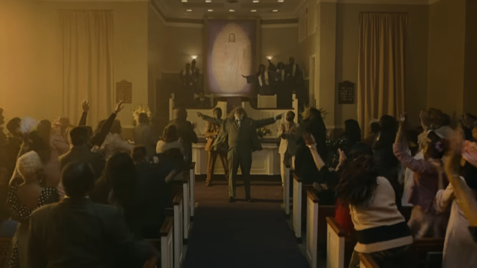 David Alan Grier as the pastor at the front of the church in They Cloned Tyrone.