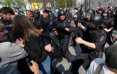 Policemen chase opposition supporters during a protest ahead of President Vladimir Putin's inauguration ceremony, Moscow, Russia May 5, 2018. REUTERS/Sergei Karpukhin