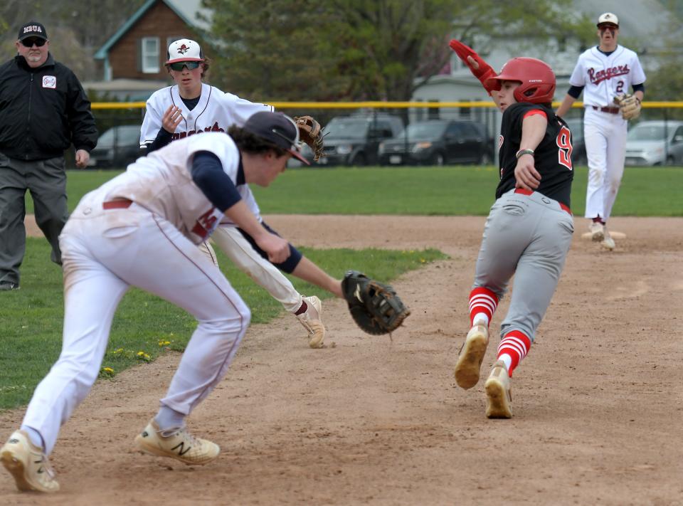 Westborough first baseman Jack Pisciotti chases St. John's Chris Pompei towards second base during a pickoff play rundown, which allowed a runner to score from third base.