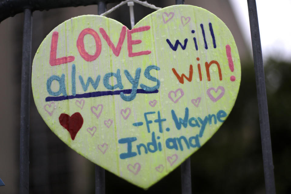 A sign hangs on a fence surrounding the Tree of Life synagogue in Pittsburgh on Saturday, Oct. 26, 2019. The first anniversary of the shooting at the synagogue that killed 11 worshippers and injured others is on Sunday, Oct., 27, 2019. (AP Photo/Gene J. Puskar)