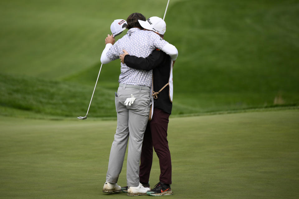 Max Homa celebrates with his caddie after winning the Wells Fargo Championship golf tournament, Sunday, May 8, 2022, at TPC Potomac at Avenel Farm golf club in Potomac, Md. (AP Photo/Nick Wass)