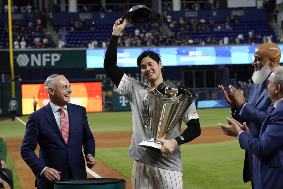 Japan's Shohei Ohtani receives the World Baseball Classic trophy on behalf of the team after defeating the United States in the World Baseball Classic championship game, Tuesday, March 21, 2023, in Miami. (AP Photo/Wilfredo Lee)