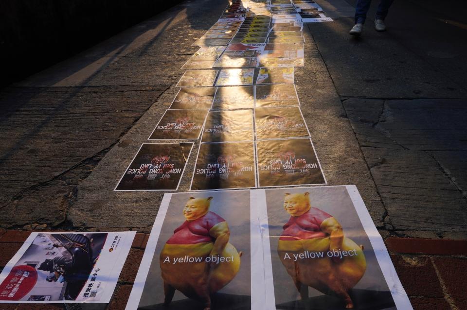 Posters, including that of a caricature of Chinese President Xi Jinping, line up a road as part of a newly created Lennon Wall, in Hong Kong, Saturday, Sept. 28, 2019. Hong Kong activists first created their own Lennon Wall during the 2014 protests, covering a wall with a vibrant Post-it notes calling for democratic reform. Five years later, protestors have gathered to create impromptu Lennon Walls across Hong Kong island. (AP Photo/Vincent Yu)