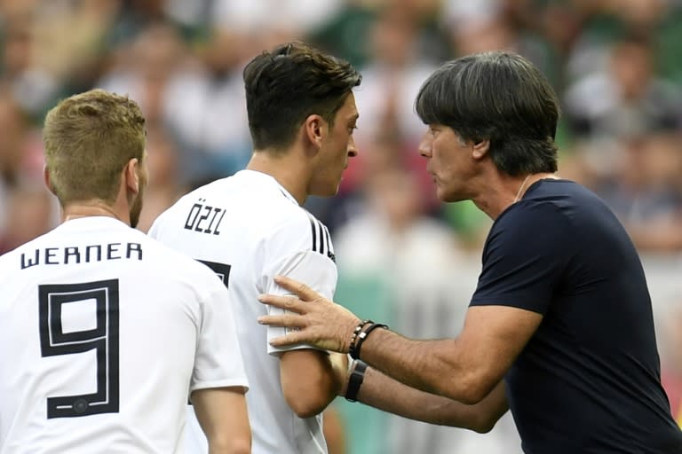 Germany head coach Joachim Loew (R) was caught out by the shock announcement of Mesut Ozil (L) that he was retiring from international duty on Sunday