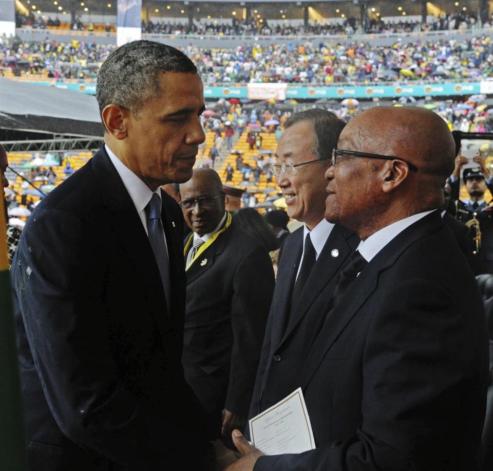 GCIS handout photo shows U.S. President Obama shaking hands with South African President Zuma at the Memorial Service for Nelson Mandela in Johannesburg