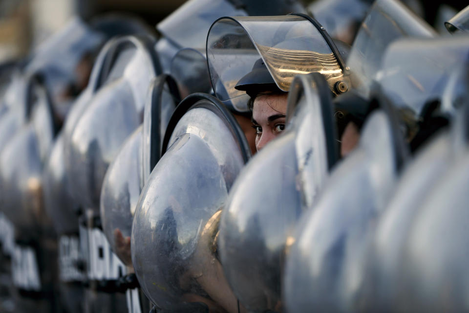 Police block a street that leads to the U.S embassy during a protest against U.S. intervention in Venezuela, in Buenos Aires, Argentina, Tuesday, Feb. 5, 2019. Venezuelan President Nicolas Maduro accuses the United States of trying to orchestrate a coup against him, and that allegation has resonance among many in a region where Washington has a long history of interventions — military and otherwise. (AP Photo/Natacha Pisarenko)