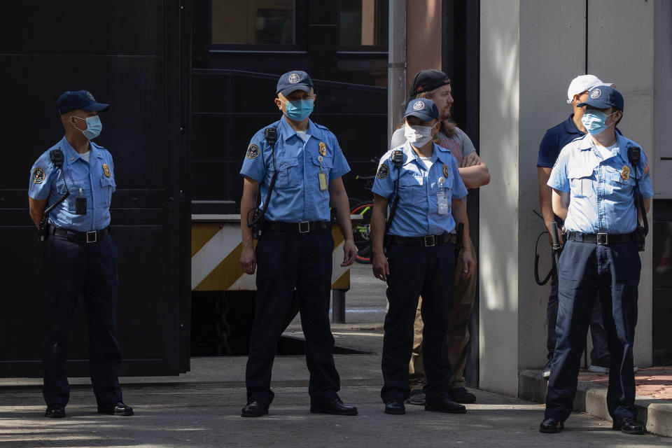 Consulate security personnel guard the entrance to the United States Consulate in Chengdu in southwest China's Sichuan province on Sunday, July 26, 2020. China ordered the United States on Friday to close its consulate in the western city of Chengdu, ratcheting up a diplomatic conflict at a time when relations have sunk to their lowest level in decades. (AP Photo/Ng Han Guan)