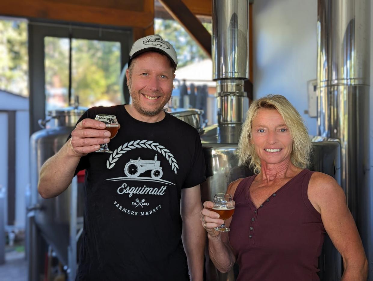 Daniel van Netten (left) has brewed classic English ales using hops grown over 100 years ago in the historic North Saanich hop farm currently owned by Lavonne Parker. (Rohit Joseph/CBC - image credit)