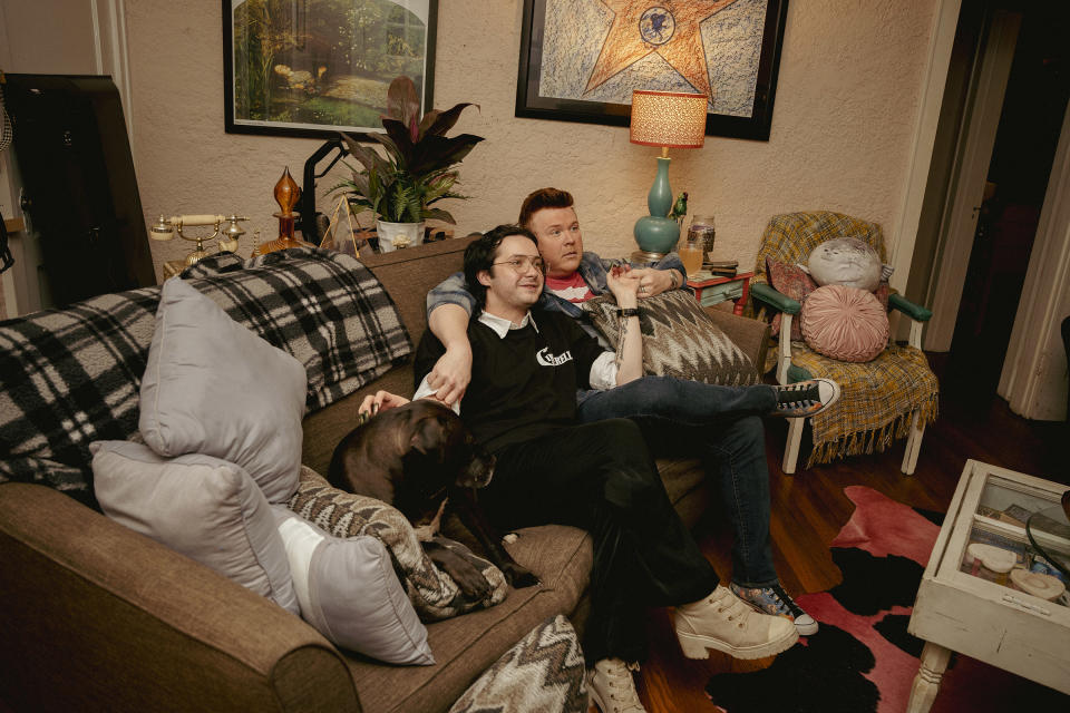 Kelly McDaniel (right) and his husband Austin Wood-McDaniel (left) hang out in their living room after working their day jobs on March 29.<span class="copyright">Andrea Morales for TIME</span>
