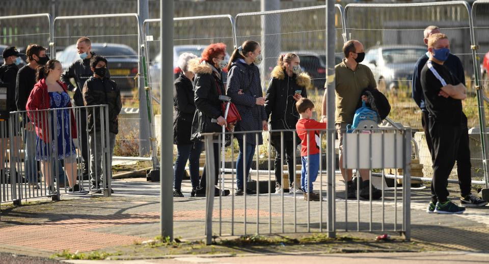 People queue to enter an NHS COVID-19 walk-in testing centre in Bolton, northern England on September 9, 2020, as local lockdown restrictions are put in place due to a spike in cases of the novel coronavirus in the city. - The UK government, which controls health policy in England, imposed tougher restrictions on Bolton, near the northwest city of Manchester, after a "very significant rise" in cases. Bolton was found to have 120 cases per 100,000 people -- the highest in the country. (Photo by Oli SCARFF / AFP) (Photo by OLI SCARFF/AFP via Getty Images)