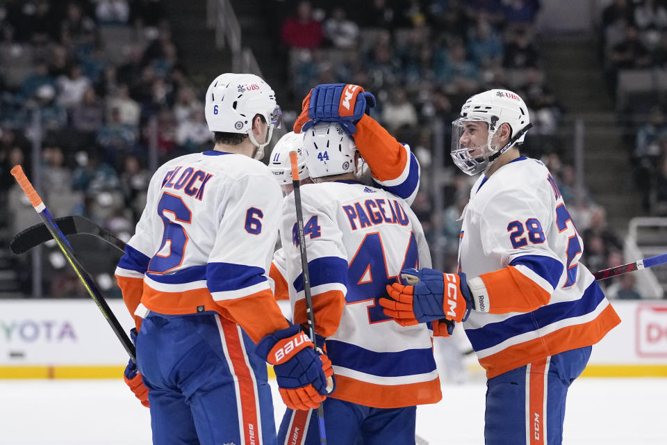 New York Islanders center Jean-Gabriel Pageau (44) celebrates with teammates after scoring a goal against the San Jose Sharks during the first period of an NHL hockey game in San Jose, Calif., Saturday, March 18, 2023. (AP Photo/Godofredo A. Vásquez)