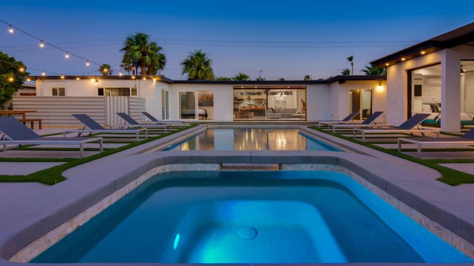 a swimming pool in front of a house